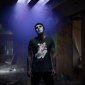 halloween-round-neck-tee-mockup-of-a-man-with-a-mask-in-a-dark-room-22950