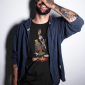 smiling-tattooed-man-wearing-a-t-shirt-while-at-a-studio-mockup-a17024