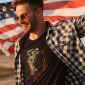 t-shirt-mockup-of-a-stylish-man-holding-an-american-flag-45789-r-el2
